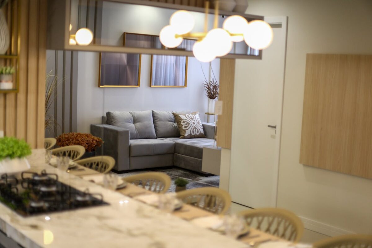 A stylish and elegant modern living room with a gray sofa and chic decor.